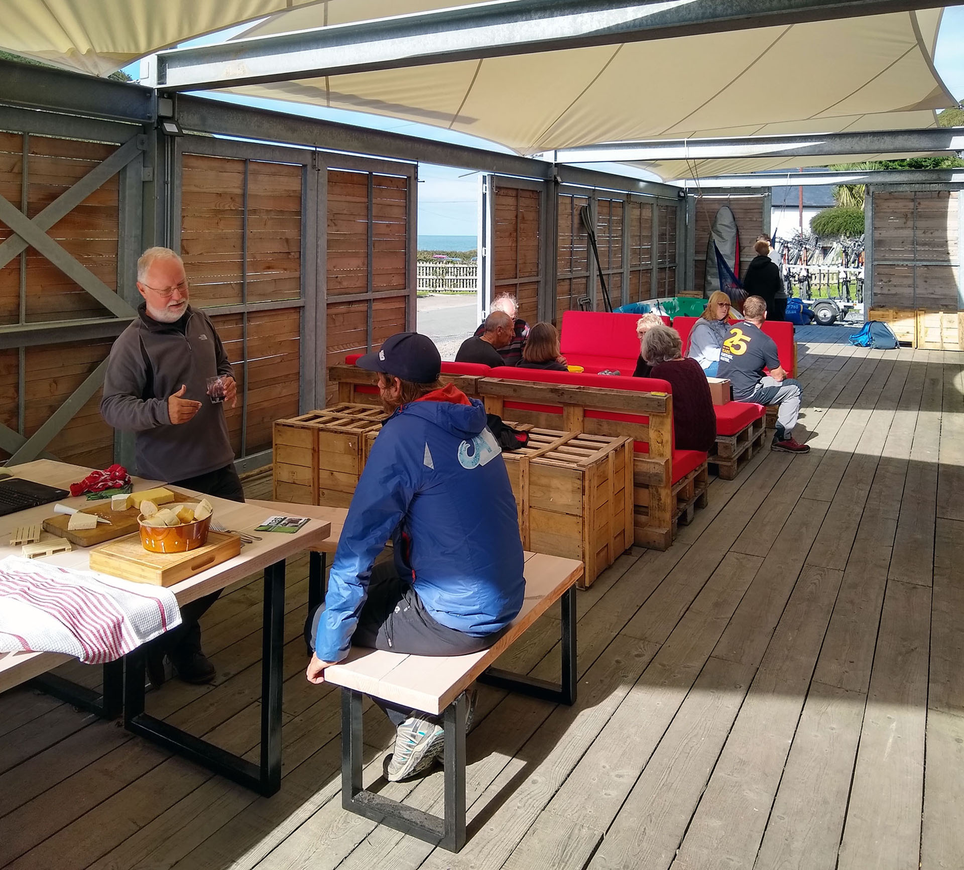 The outdoor deck, with a huge dining table, sitting area,and play areas